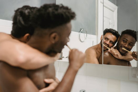 Two men sharing a joyful morning routine, brushing teeth together.