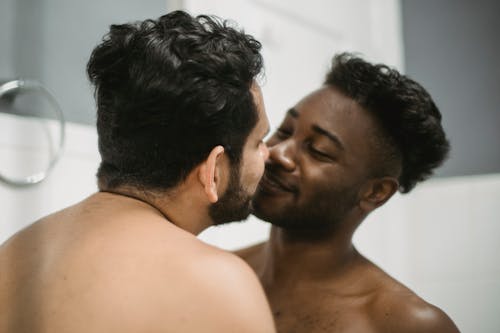 Two Shirtless Men Being Affectionate