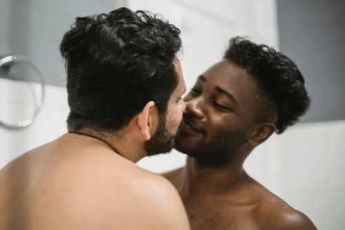 Free Intimate moment captured between a loving interracial couple expressing affection. Stock Photo