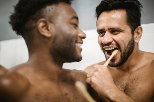 A cheerful couple shares an intimate moment while brushing their teeth together, embracing joy and connection.