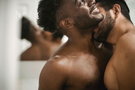 Shirtless Man Kissing Other Undressed Man on Neck