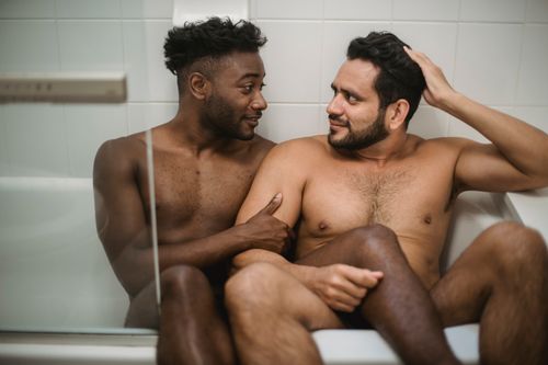 Free Two men share a loving, intimate moment in the bathtub, showcasing affection and togetherness. Stock Photo