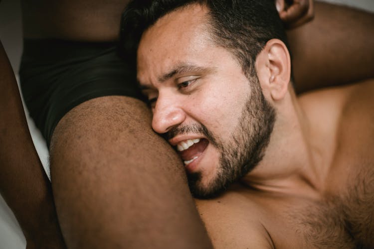 Man Having His Head On A Thigh Of Another Man