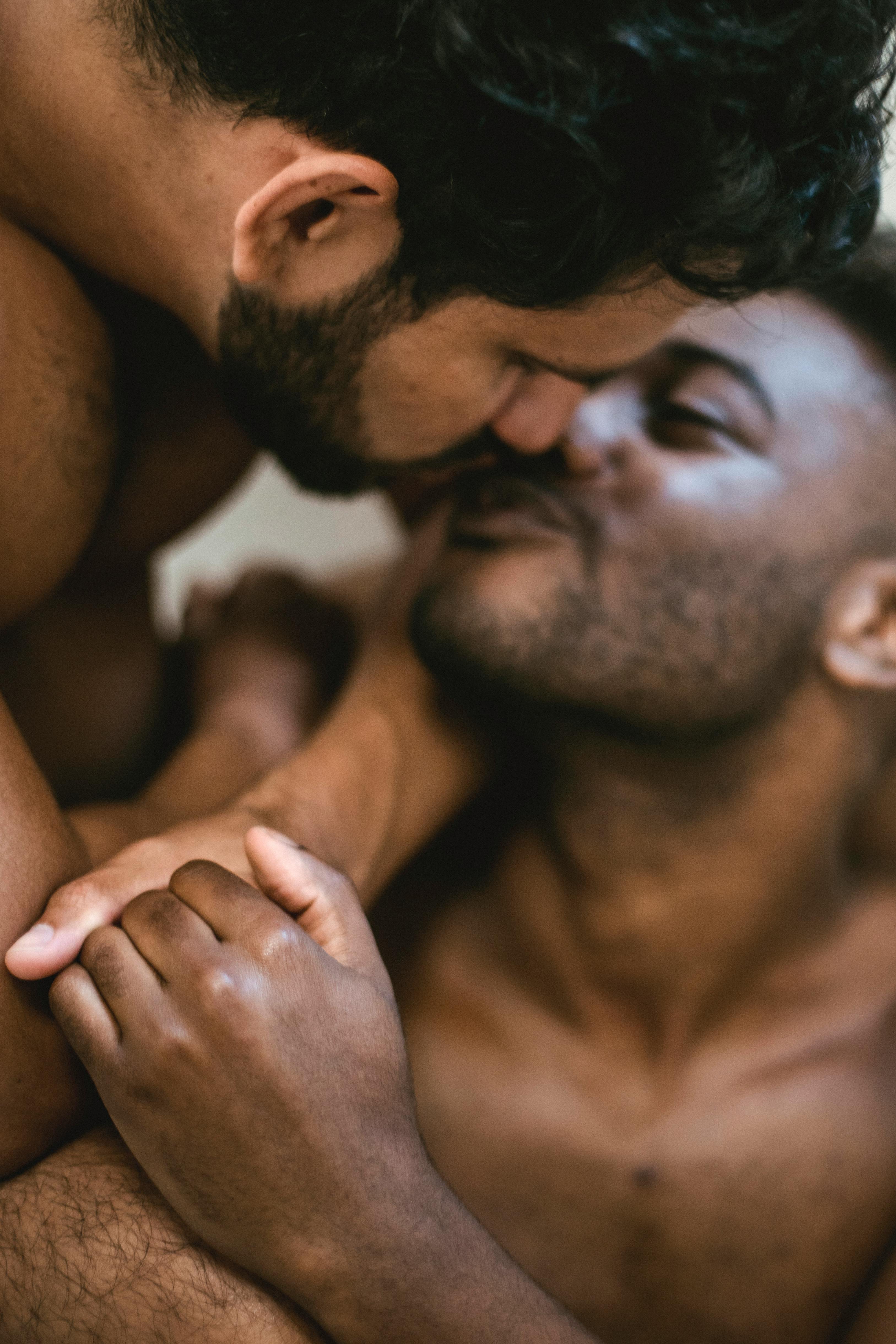 two men kissing and holding hands