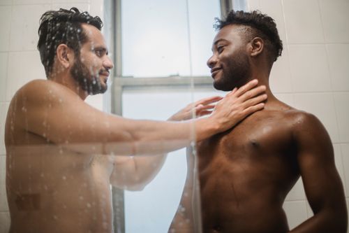Free An intimate moment shared by a loving couple in a shower, exuding warmth and affection. Stock Photo