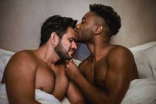 Free Man Kissing Another Man on the Forehead Stock Photo
