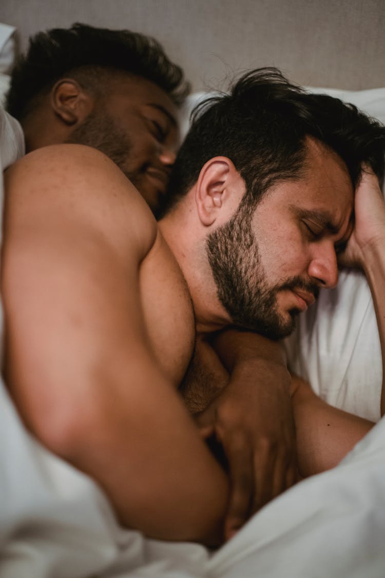 Couple Sleeping Together In Bed