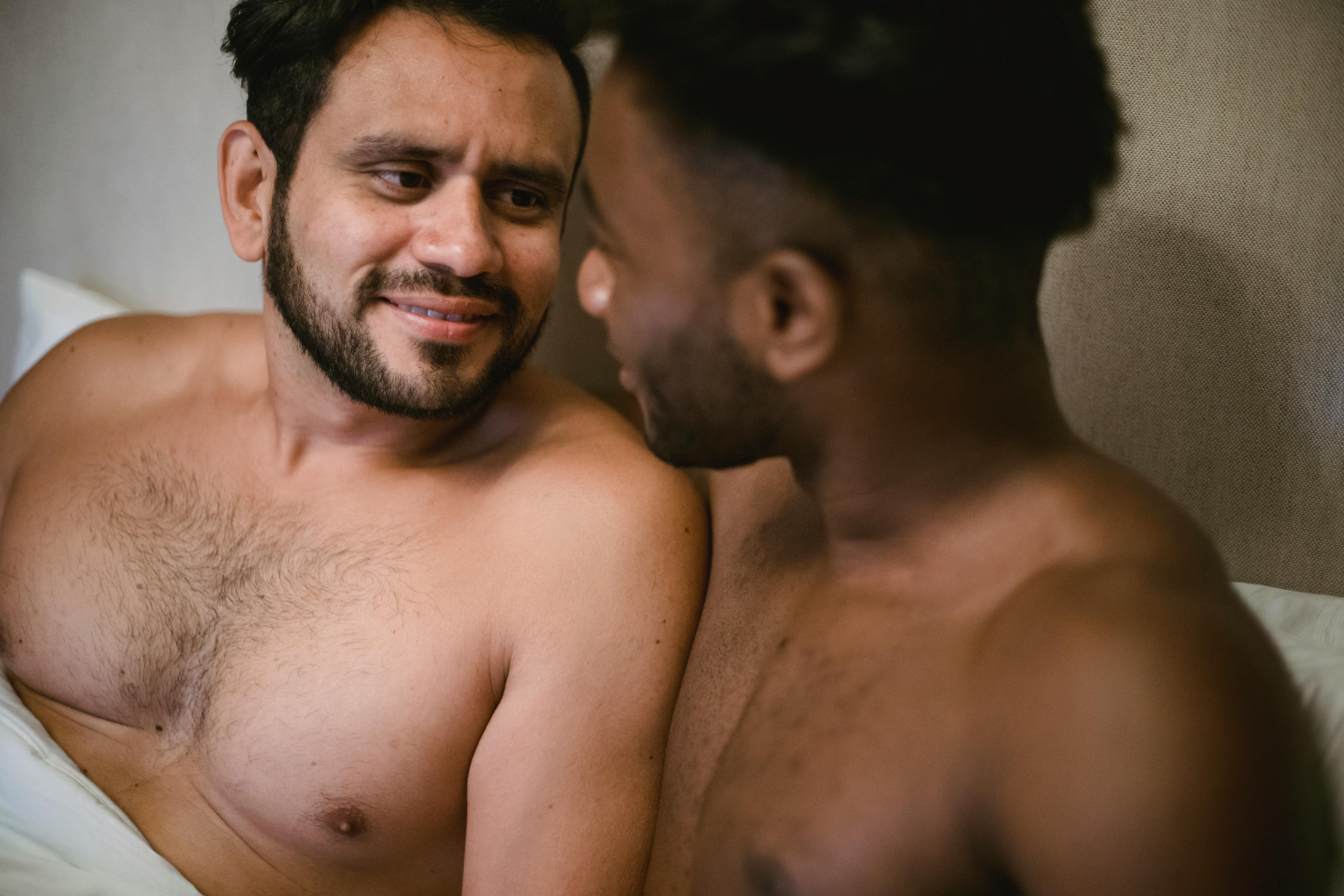 portrait of men lying in bed together