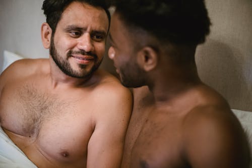 Free Portrait of Men Lying in Bed Together Stock Photo