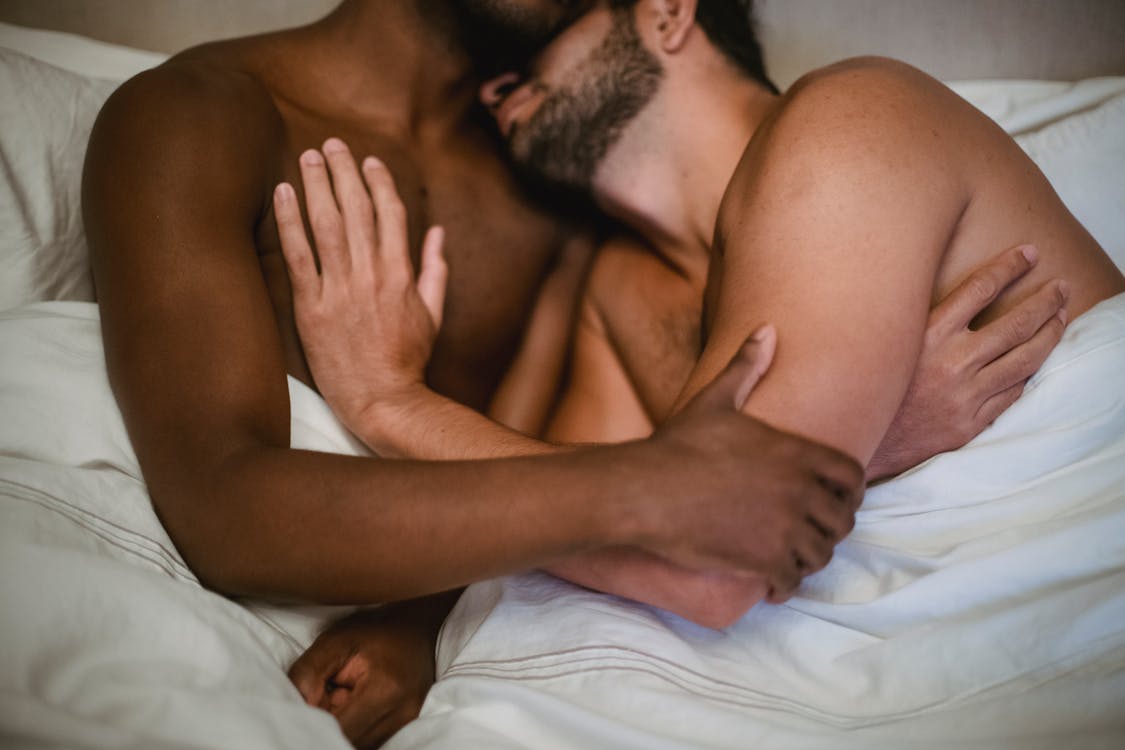 Free Close-up of Men Lying in Bed Hugging Stock Photo
