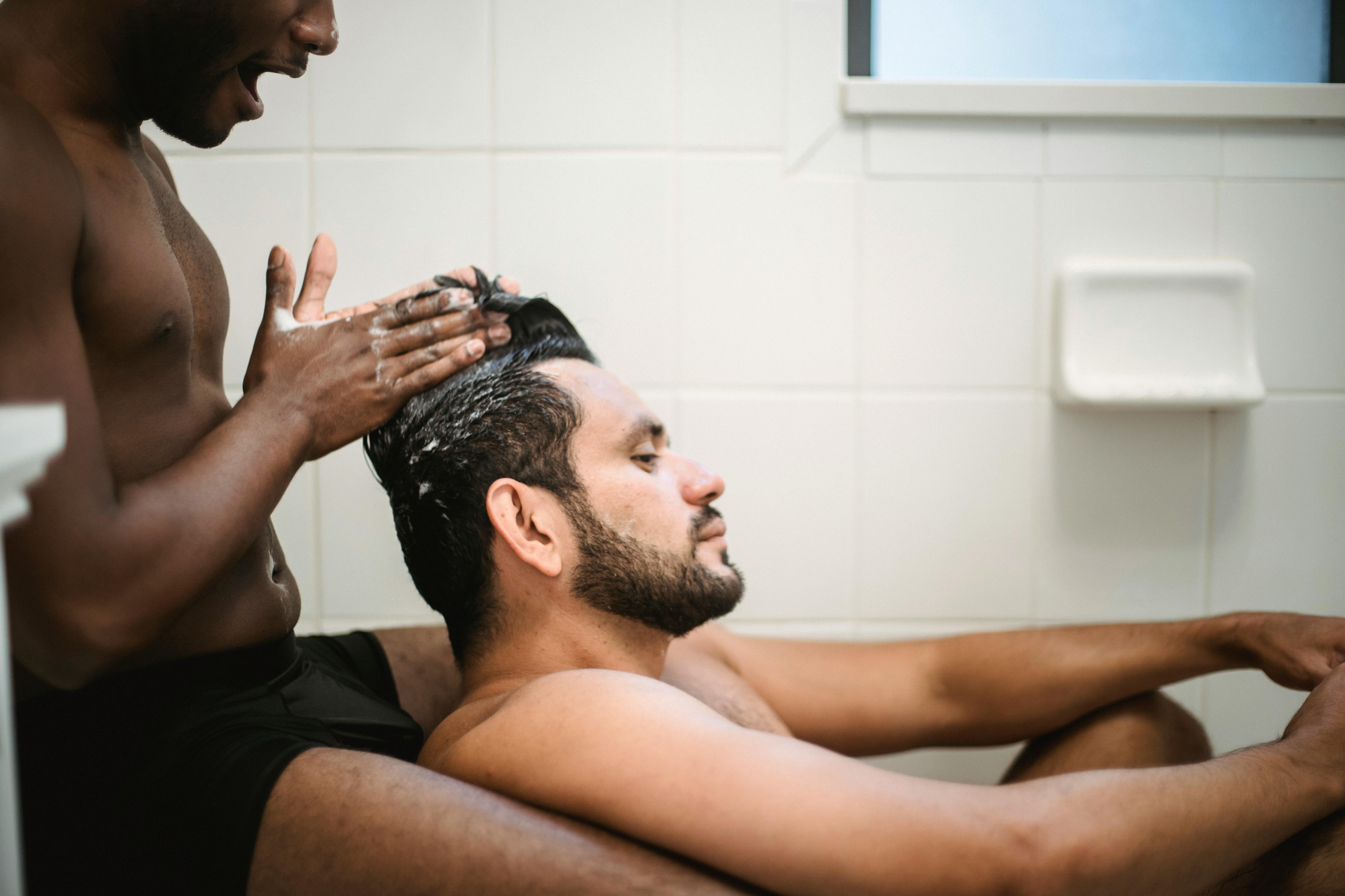 man washing another man s hair