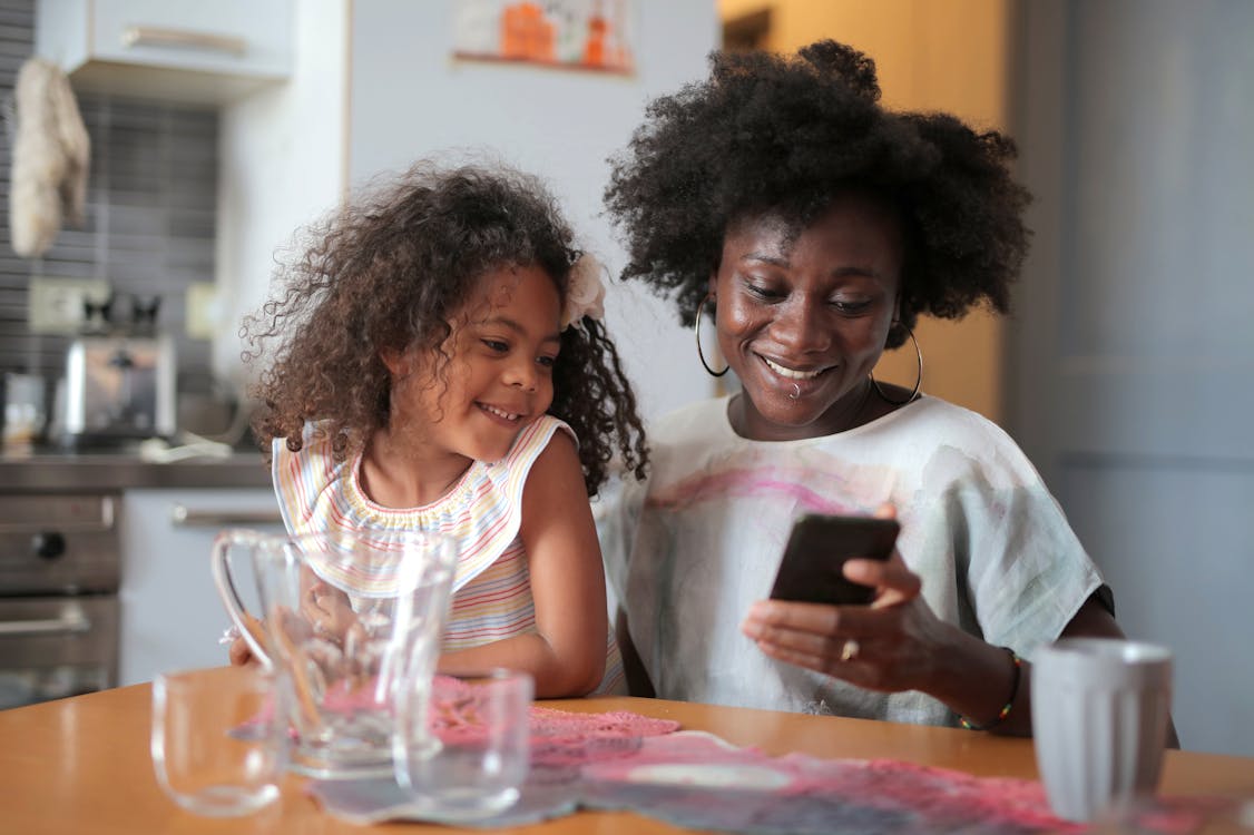 Mother and Daughter by Table