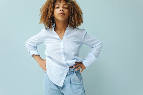 Woman in White Dress Shirt and Blue Denim Jeans