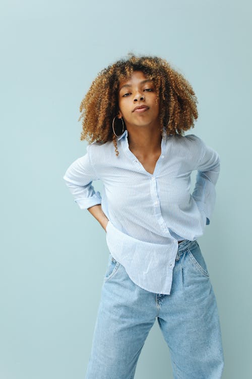 Woman Wearing a Dress Shirt and Blue Denim Jeans