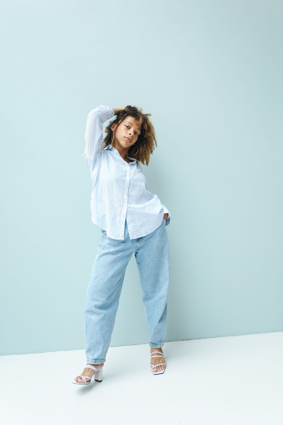 Woman smiling in a white tee and jeans