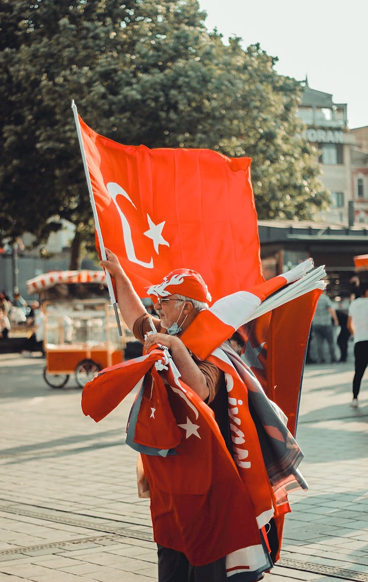 A Man Holding Turkish Flag On The Street