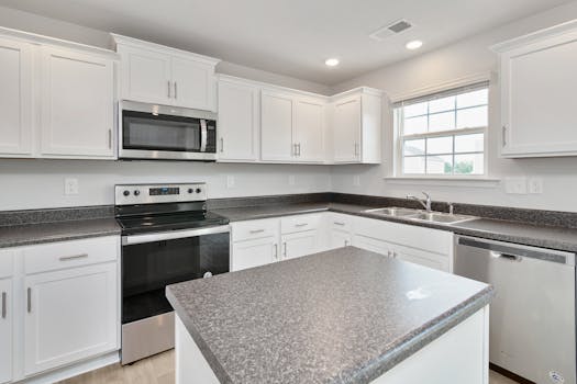 Bright white kitchen featuring stainless steel appliances and sleek countertops.