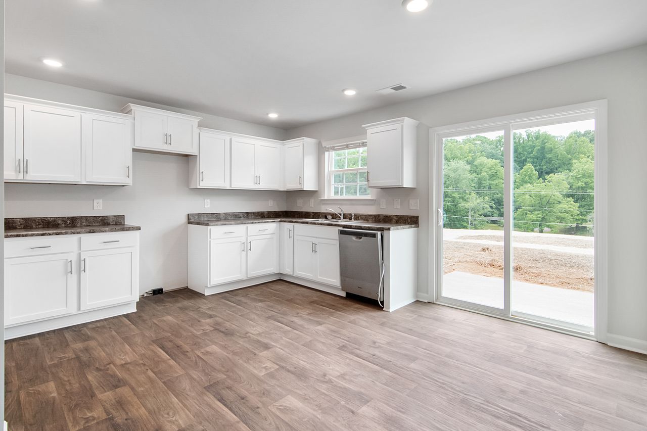 kitchen-gallery-white-cabinets Spacious modern kitchen with white cabinets and greenery