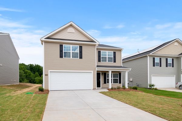 Brick home with landscaped yard, photo by Curtis Adams on Pexels