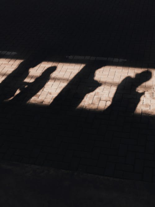 Free Shadows of people on concrete tile on street Stock Photo