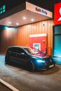 Contemporary car parked near drive thru at night