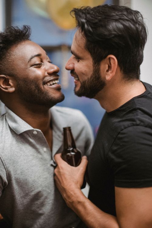 Free Two joyful men smiling and facing each other, capturing a moment of happiness indoors. Stock Photo