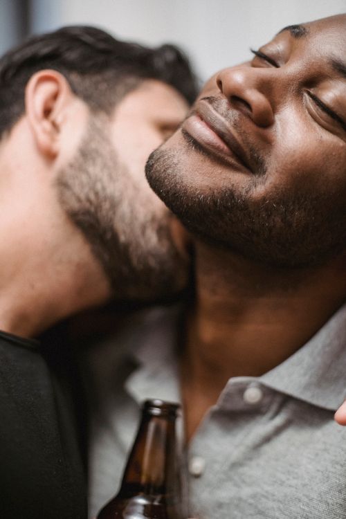Free Close portrait of two men sharing an intimate moment, expressing affection. Stock Photo