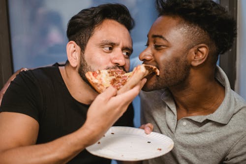 Two Men Eating a Pizza Together