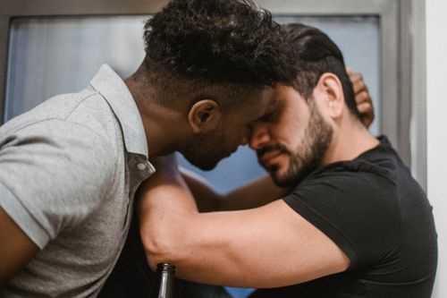 Free A close-up shot of two men sharing an intimate moment. Perfect for themes of love and connection. Stock Photo