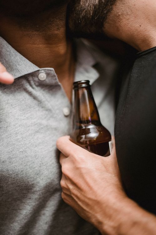 Free Intimate close-up of a couple with a bottle, highlighting connection and affection. Stock Photo