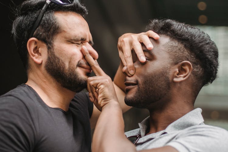 Men Holding Each Others Noses