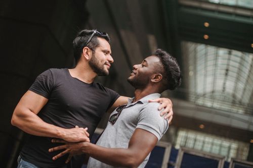 Free A tender moment shared between two men embracing indoors, reflecting deep affection and connection. Stock Photo