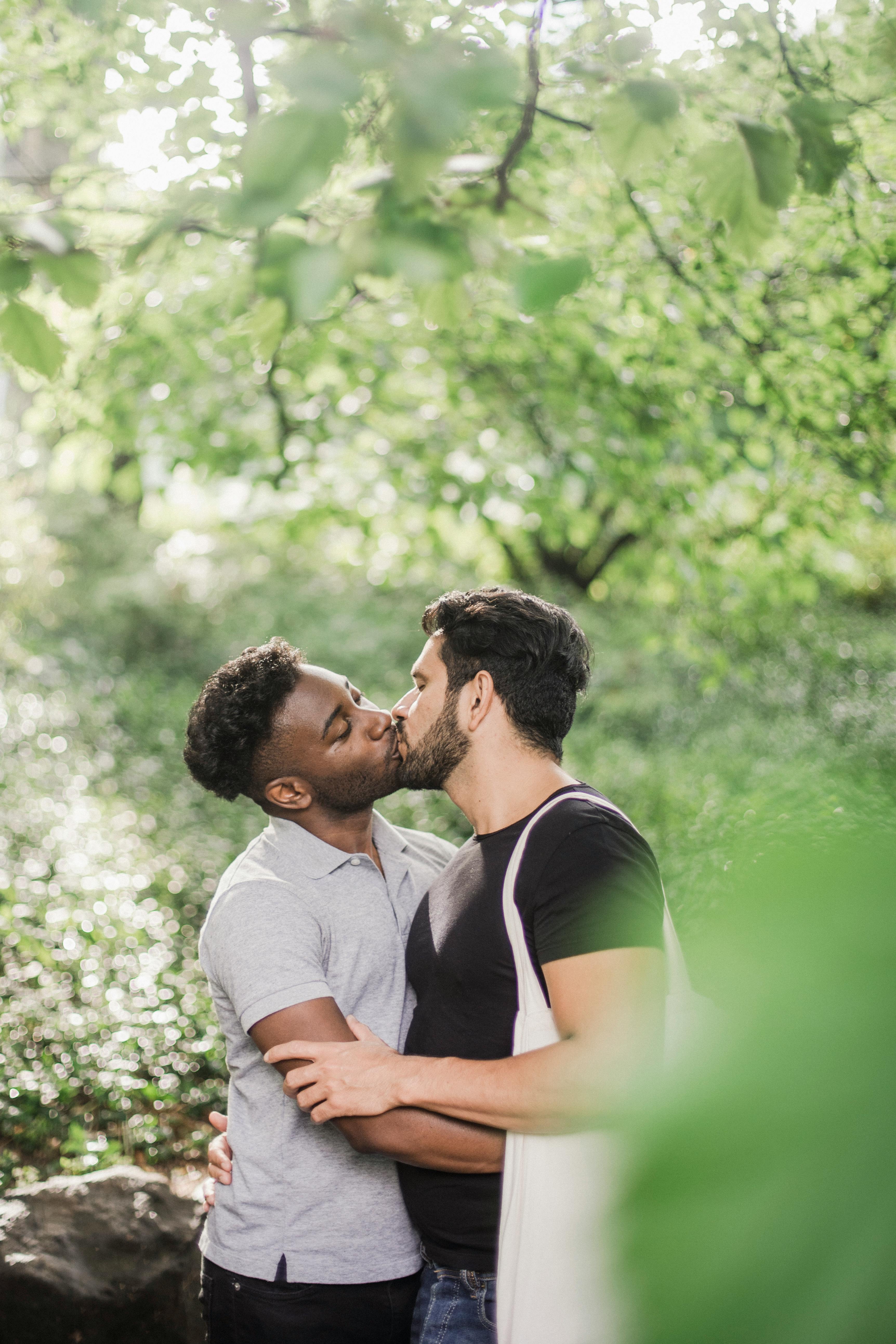 two men kissing outside