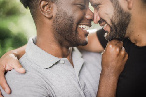 Photo of Men Doing Nose to Nose while Smiling