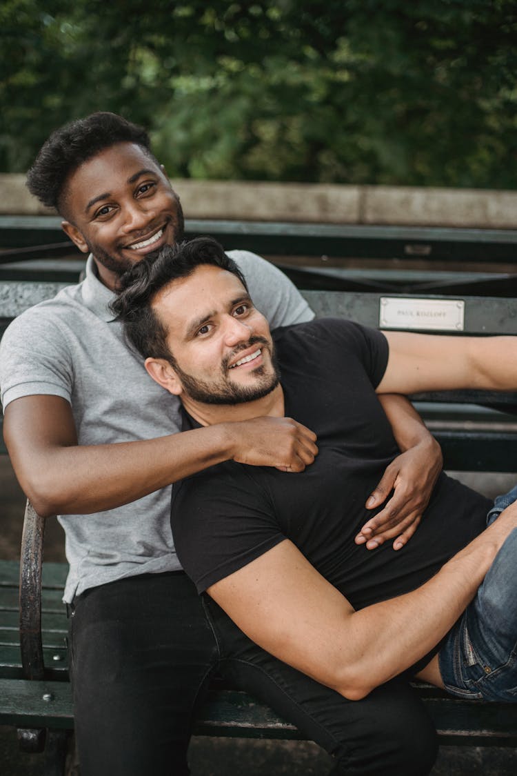 Portrait Of Couple Cuddle With Affection On Bench