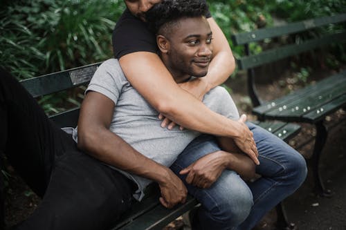 Free Man in a Gray Shirt Lying on Another Person's Lap Stock Photo