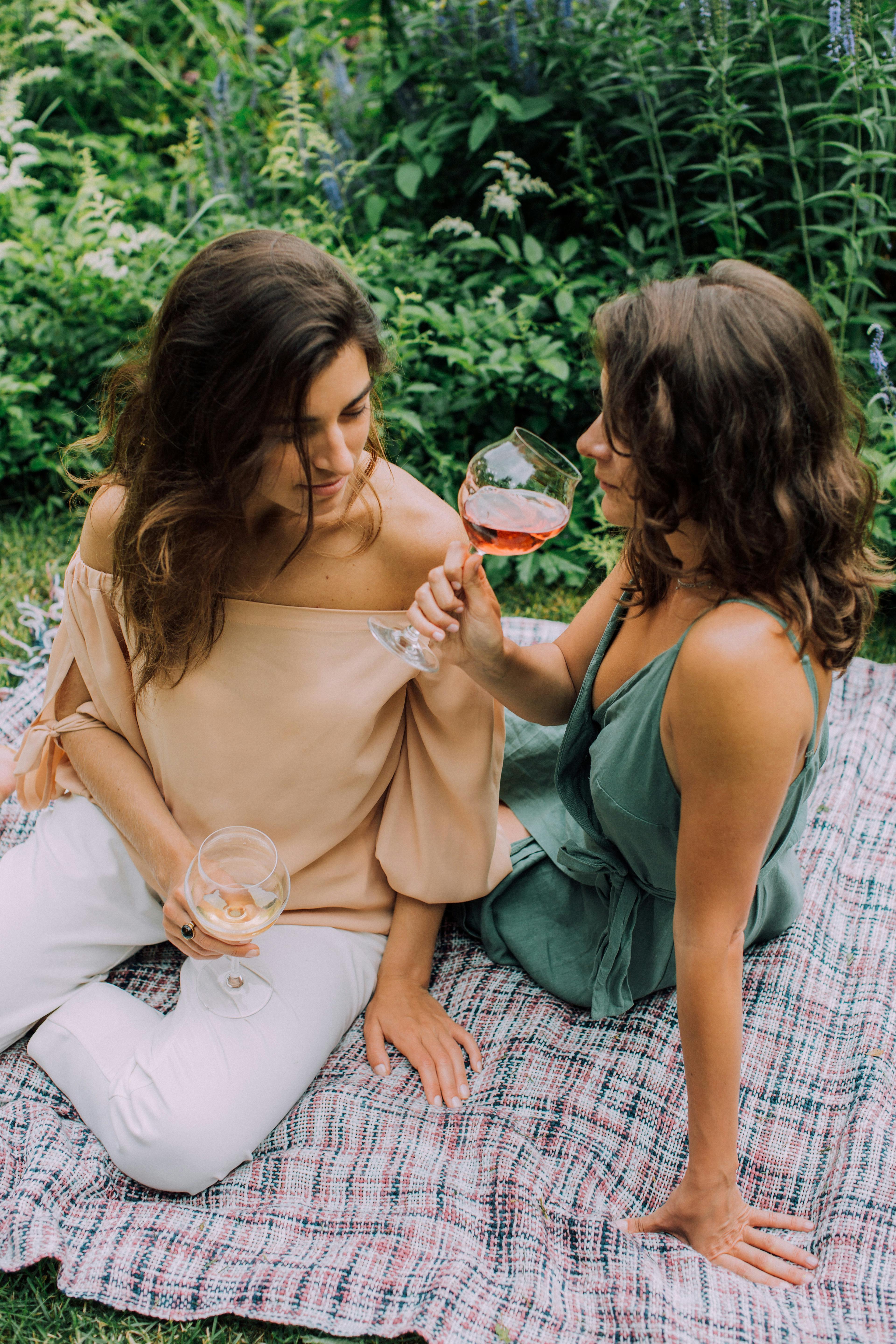 photograph of women with brown hair having a picnic together