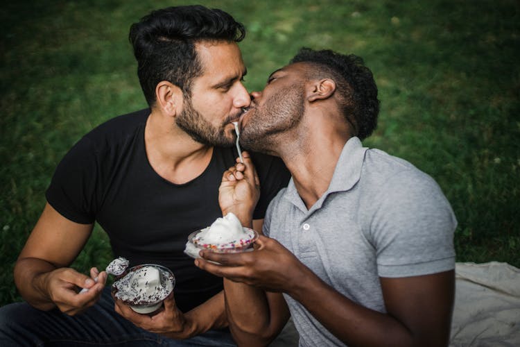 Two Men Kissing And Sharing An Ice Cream