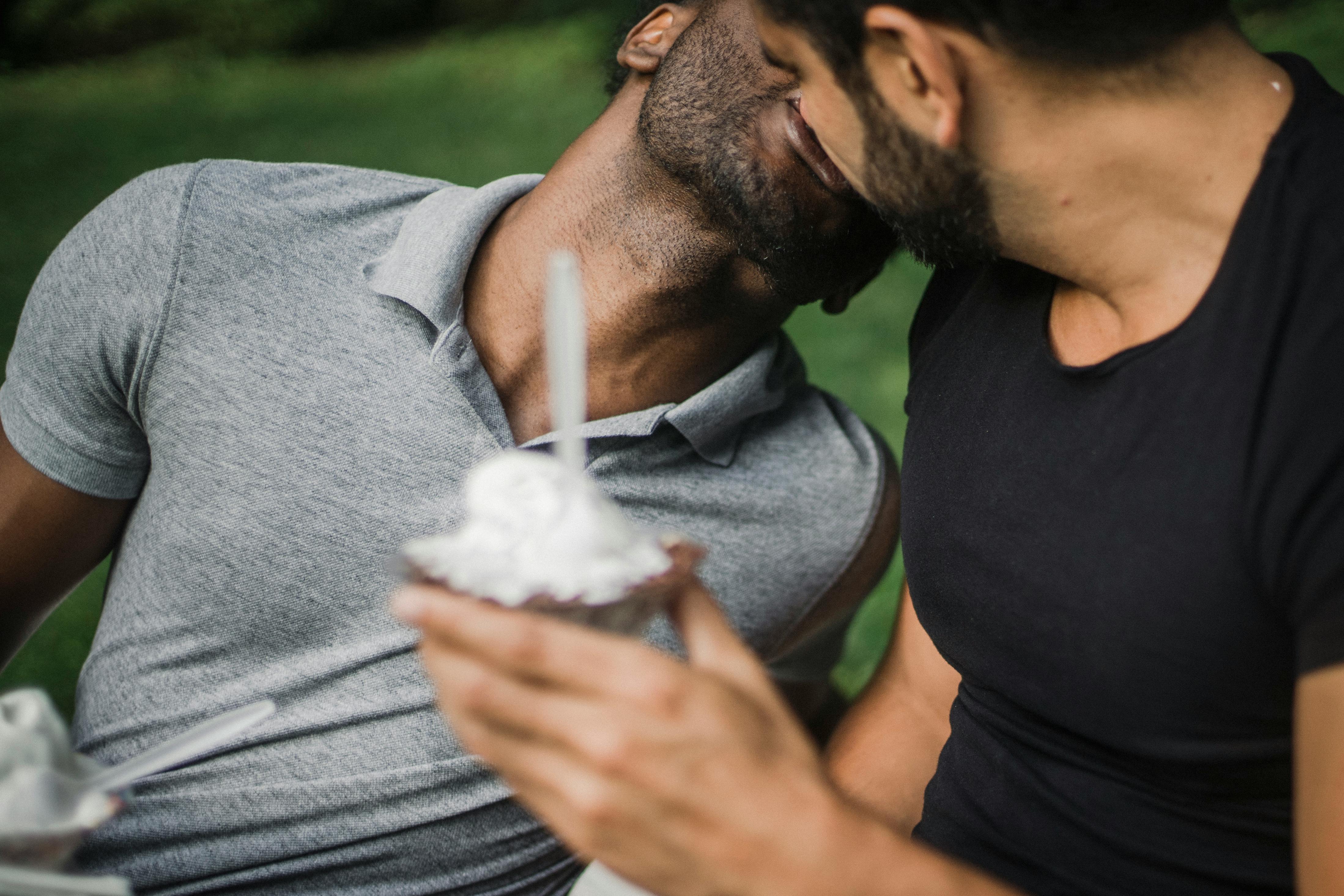 Two Men Holding an Ice Cream and Kissing · Free Stock Photo