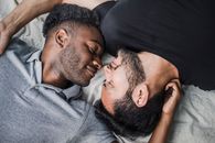 Gay Lovers Laying and Looking into Each Other Eyes with Affection