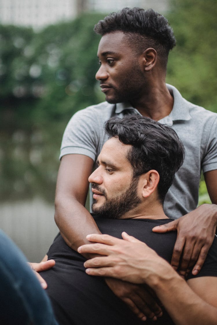 Portrait Of Couple Cuddle With Affection On Bench