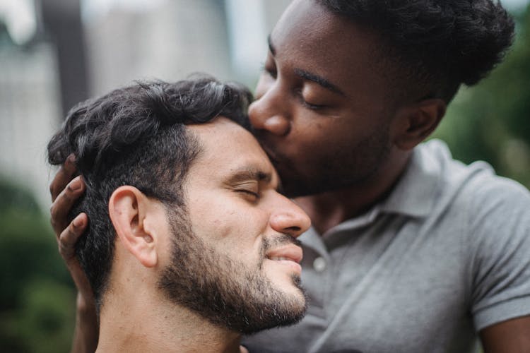 Man Kissing Partner On Forehead