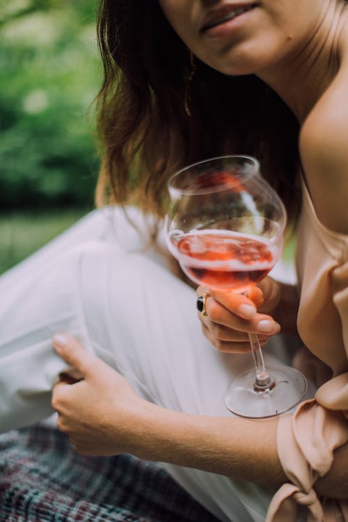 Close Up Photo of Woman Holding a Wine Glass