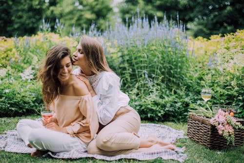 Free Women Sitting on a Picnic Blanket Stock Photo