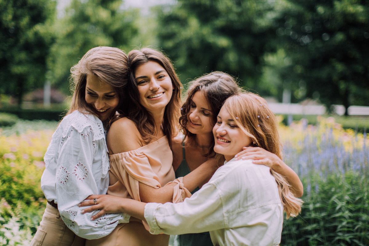 Group of women friends hugging and celebrating — graduation gift ideas