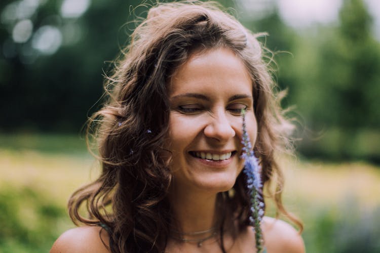 A Happy Woman Looking The Flower