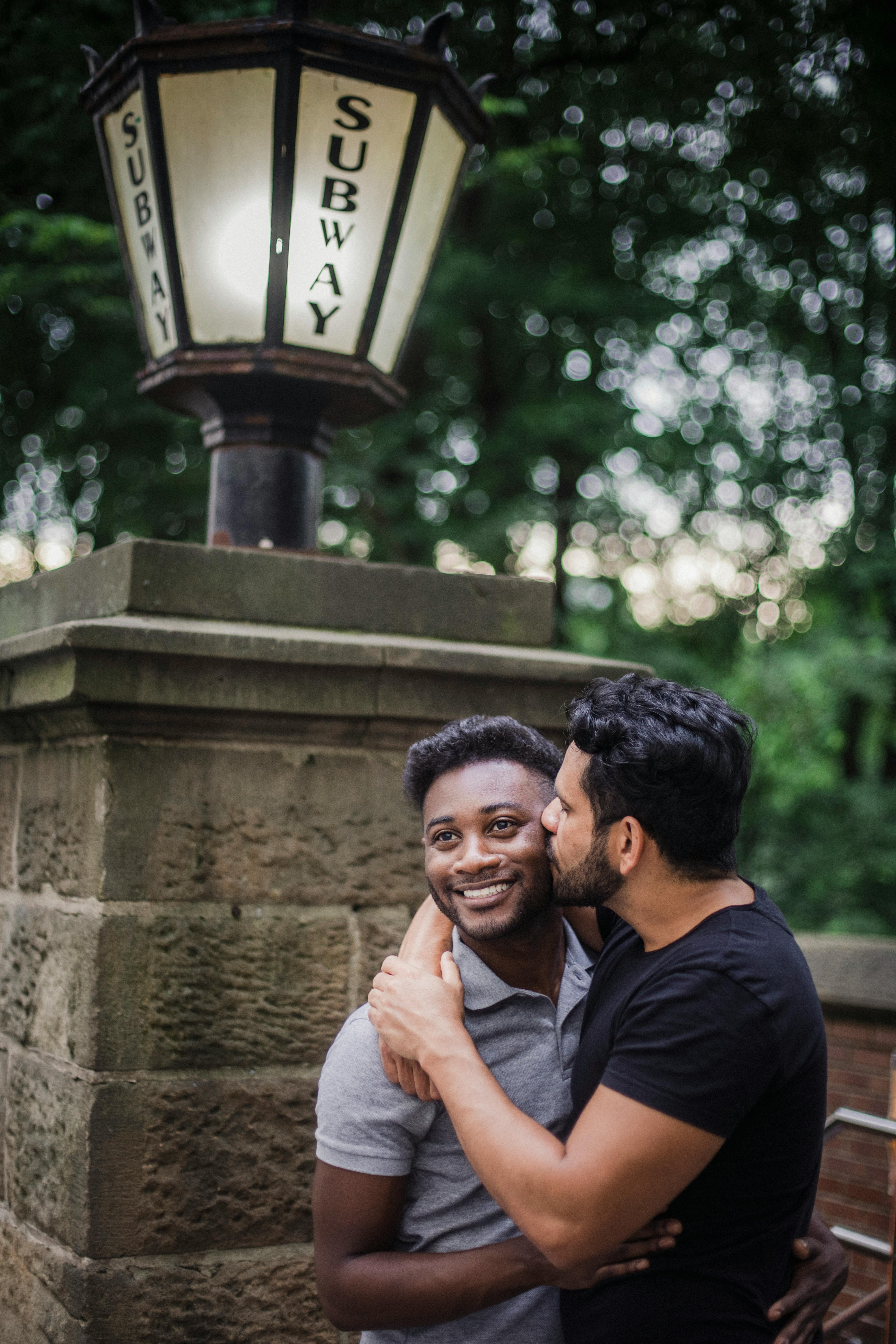 couple kissing by subway entrance