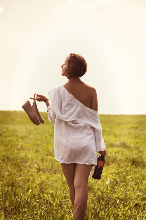Carefree woman walking in field in summertime