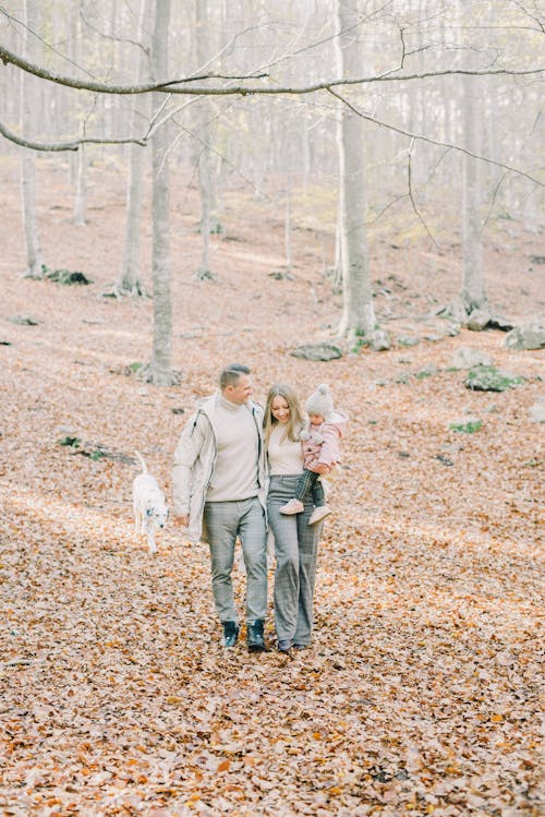A Happy Family Walking Together in the Woods