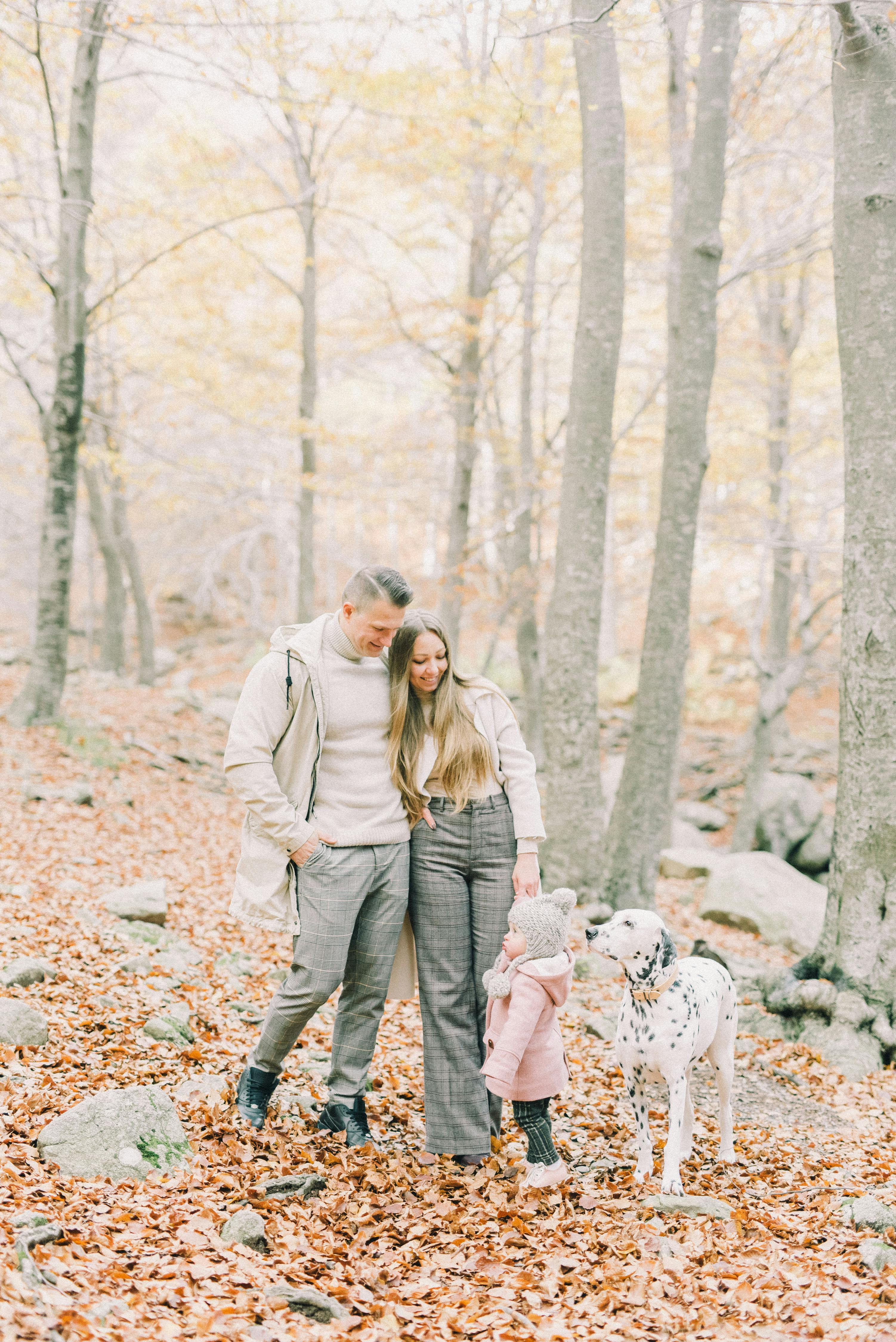 a happy family in the woods with their dog